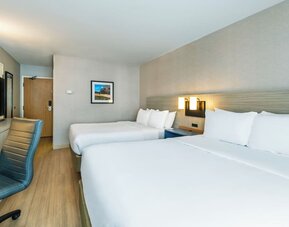 Modern guest room with two queen beds, comfortable bedding, and ample space for families or groups at Comfort Inn Airport East Ancienne-Lorette.