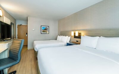Modern guest room with two queen beds, comfortable bedding, and ample space for families or groups at Comfort Inn Airport East Ancienne-Lorette.