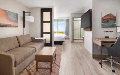 Spacious suite featuring a separate living area, sofa sleeper, dedicated workspace, and modern amenities at Hyatt Place Scottsdale/Old Town.