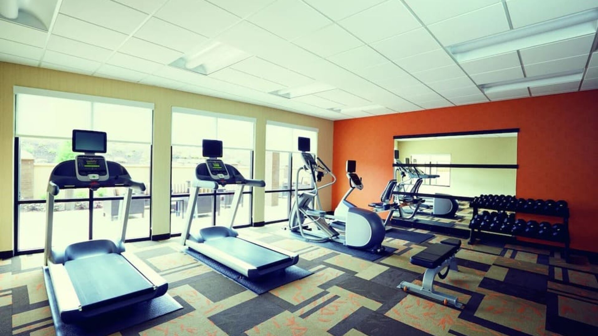 Well-equipped fitness center with treadmills, elliptical machines, free weights, and strength-training equipment at Courtyard Riverside UCR/Moreno Valley Area.