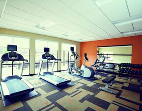 Well-equipped fitness center with treadmills, elliptical machines, free weights, and strength-training equipment at Courtyard Riverside UCR/Moreno Valley Area.
