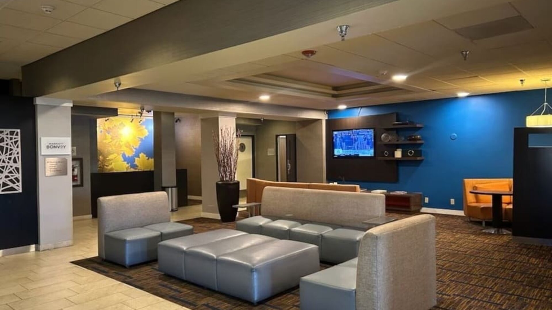 Contemporary hotel lobby with comfortable lounge seating, modern décor, and welcoming social spaces at Courtyard Riverside UCR/Moreno Valley Area.