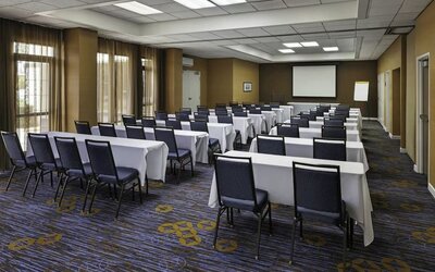 Flexible meeting room with classroom-style seating, audiovisual capabilities, and natural light for conferences and events at Courtyard Riverside UCR/Moreno Valley Area.