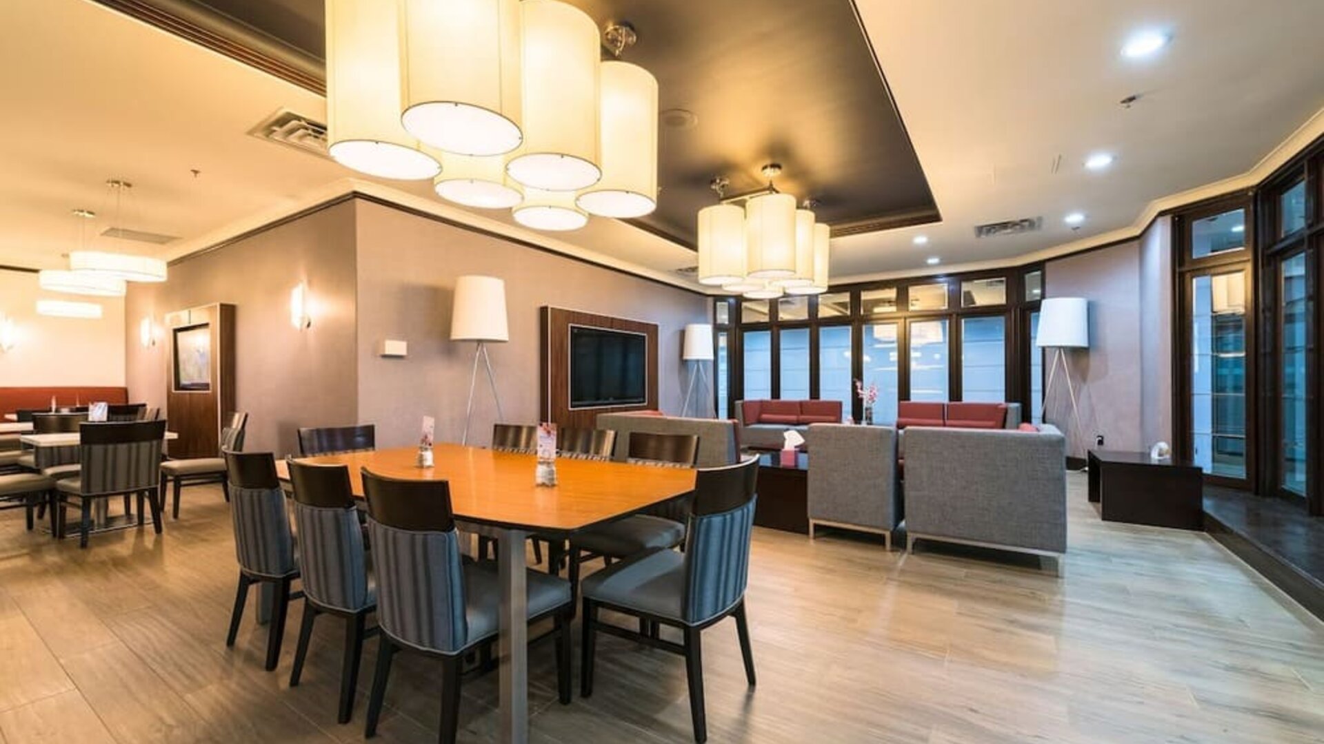 Restaurant and lounge seating area with modern décor at Holiday Inn Express Edmonton Downtown, an IHG Hotel.