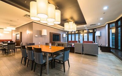 Restaurant and lounge seating area with modern décor at Holiday Inn Express Edmonton Downtown, an IHG Hotel.