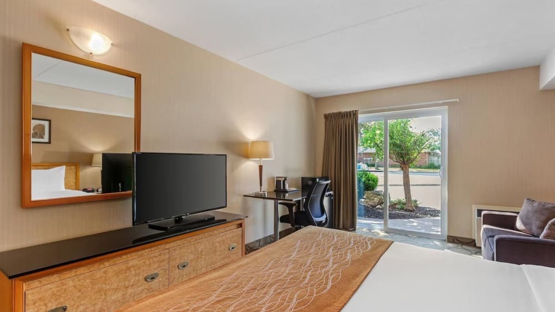 Guest room with a king bed and direct outdoor access at Comfort Inn Brantford.
