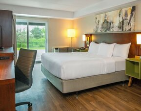 Spacious king guest room with a sofa and work desk at Comfort Inn Sault Ste. Marie.