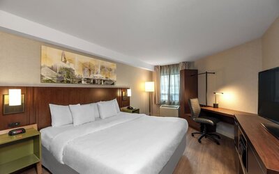 King guest room with a work desk and wardrobe at Comfort Inn Sault Ste. Marie.