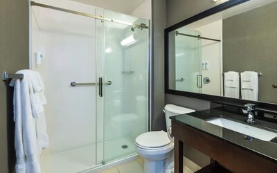 Guest bathroom with a walk-in shower and vanity at Comfort Inn Sault Ste. Marie.