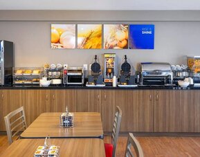 Breakfast buffet with self-serve dining area at Comfort Inn Sault Ste. Marie.