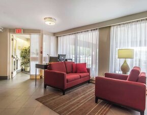 Lobby seating area with large windows at Comfort Inn Sault Ste. Marie.