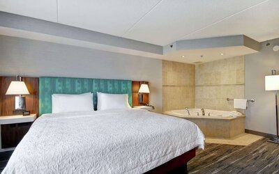 Guest room with a king bed and in-room whirlpool tub at Hampton Inn & Suites By Hilton Guelph.