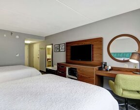 Guest room with two queen beds, work desk, TV, microwave, and mini fridge at Hampton Inn & Suites By Hilton Guelph.