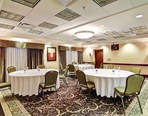 Meeting room with round table seating at Hampton Inn & Suites By Hilton Guelph.