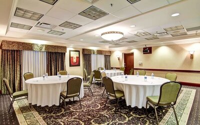 Meeting room with round table seating at Hampton Inn & Suites By Hilton Guelph.