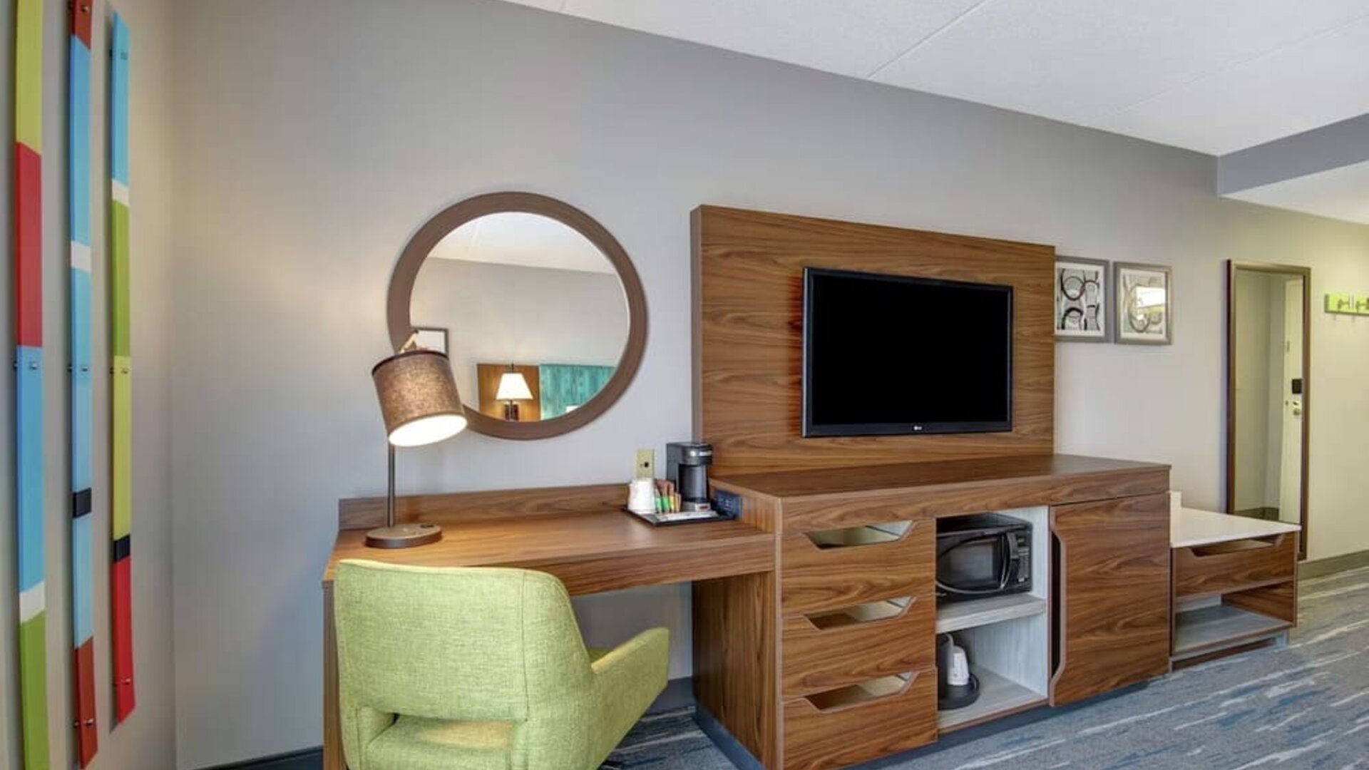 In-room workspace with a TV, microwave, mini fridge, and coffee station at Hampton Inn & Suites By Hilton Guelph.