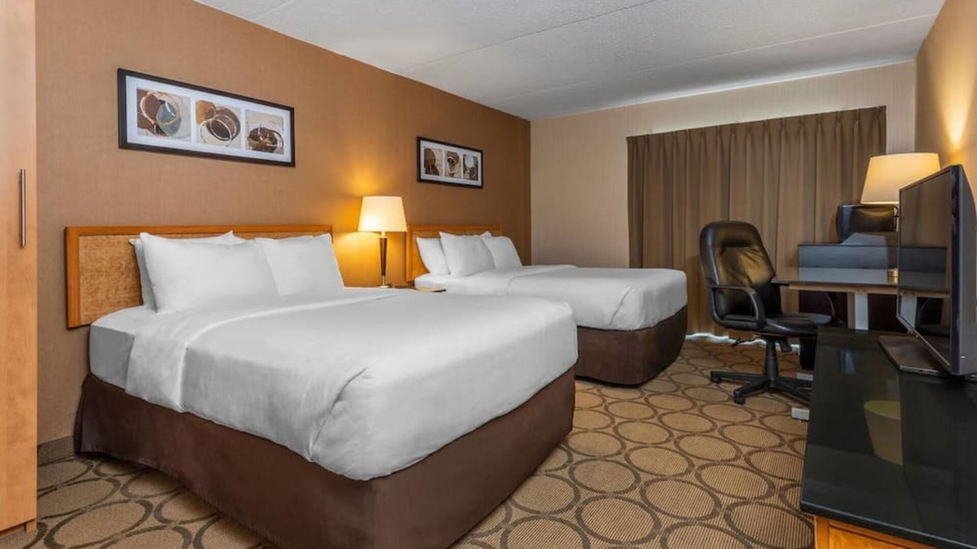 Guest room with two queen beds and a work desk at Comfort Inn Brandon.