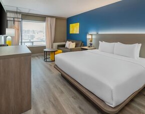 Guest room with a king bed, work desk, and seating area at Comfort Inn Belleville.