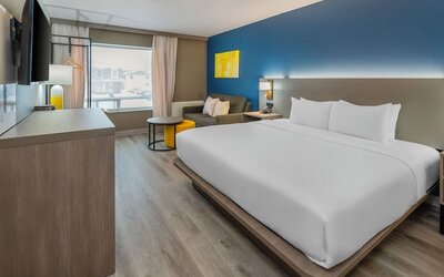 Guest room with a king bed, work desk, and seating area at Comfort Inn Belleville.