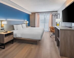 Spacious guest room with a king bed and work desk at Comfort Inn Belleville.