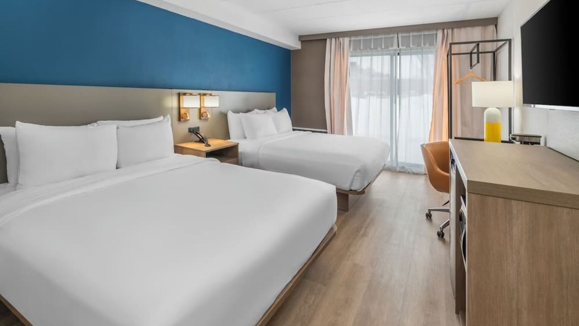 Guest room with two queen beds and modern furnishings at Comfort Inn Belleville.