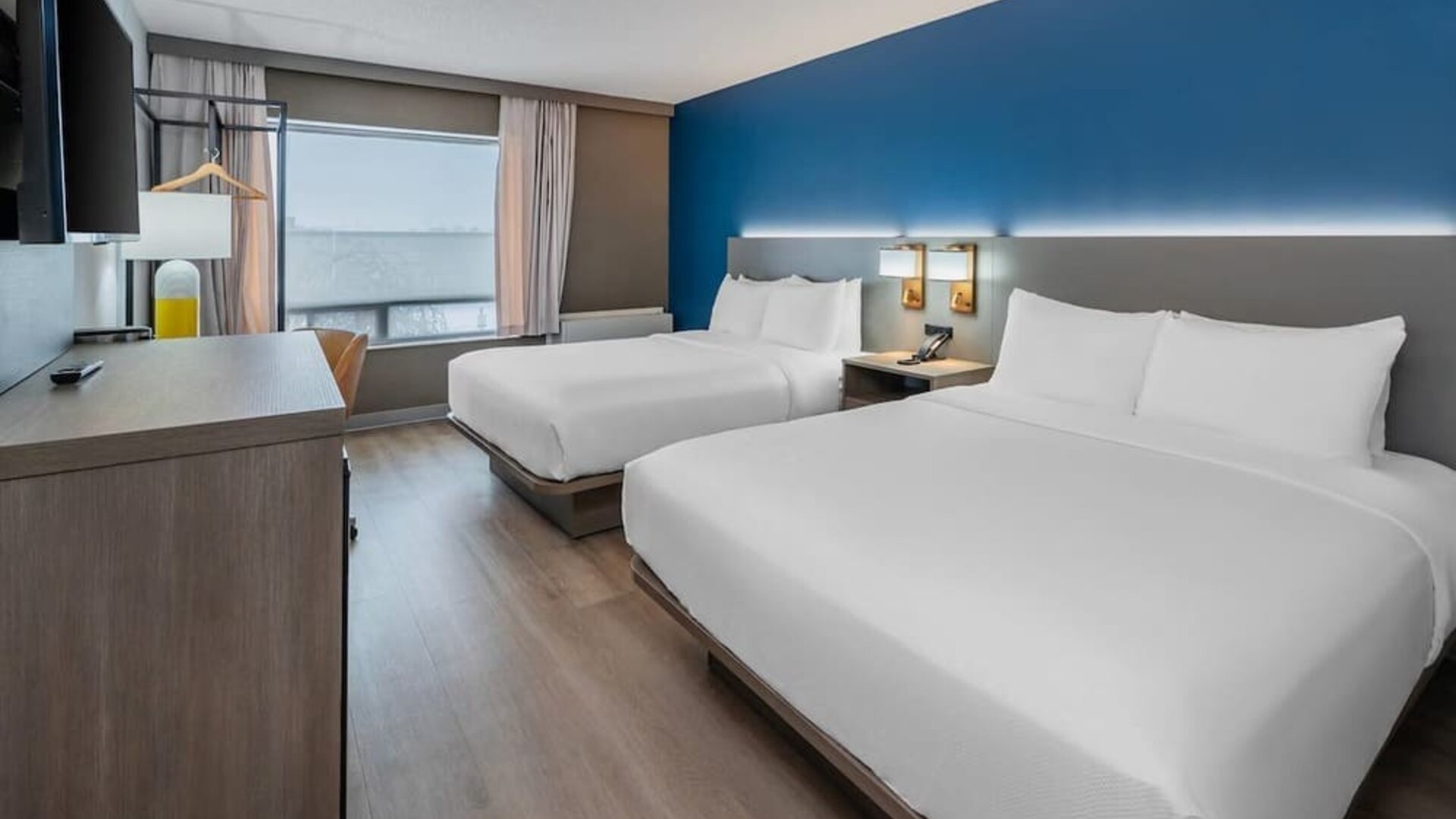 Guest room with two queen beds and large window at Comfort Inn Belleville.
