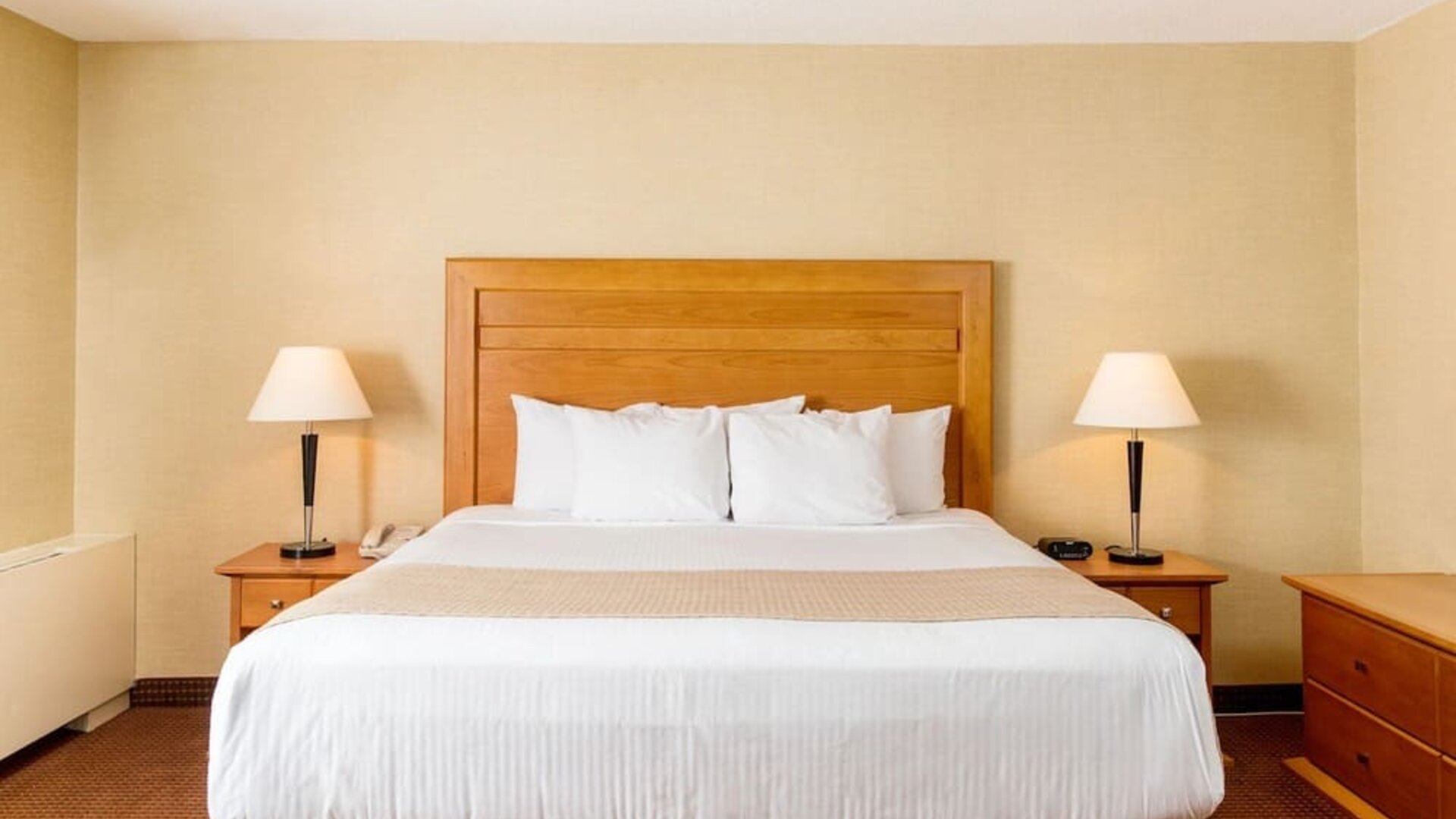 Guest room with a king bed and bedside tables at Days Inn Edmonton Downtown.