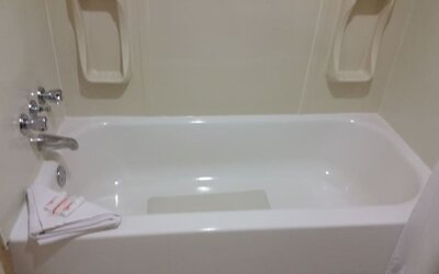 Guest bathroom with a bathtub and shower combination at Days Inn Edmonton Downtown.