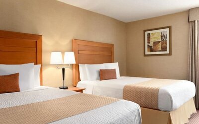 Guest room with two double beds and bedside lighting at Days Inn Edmonton Downtown.