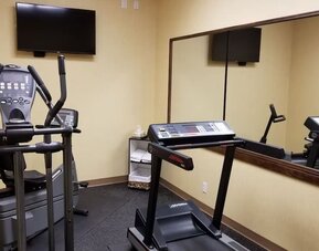 Fitness center with a treadmill and elliptical machine at Days Inn Edmonton Downtown.