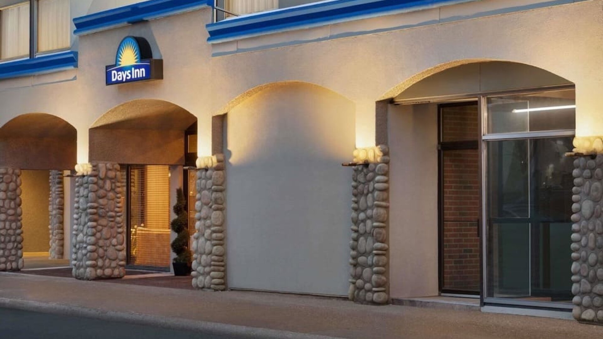Hotel entrance with covered driveway at Days Inn Edmonton Downtown.
