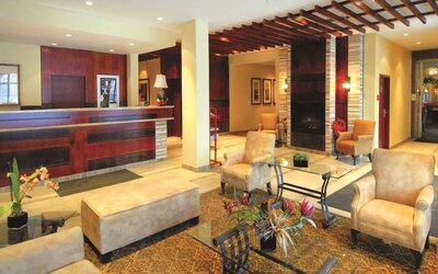 Hotel lobby with seating area and reception desk at Days Inn Edmonton Downtown.