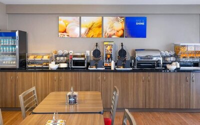 Complimentary breakfast station with waffles, cereals, and hot beverages at Comfort Inn Val D'Or.