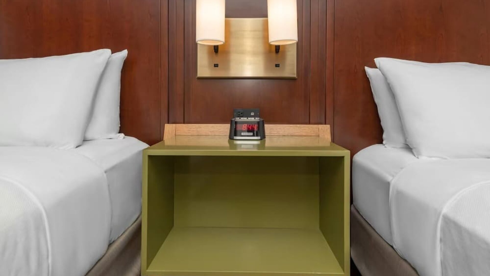 Nightstand between two beds with bedside lighting at Comfort Inn Ottawa East.