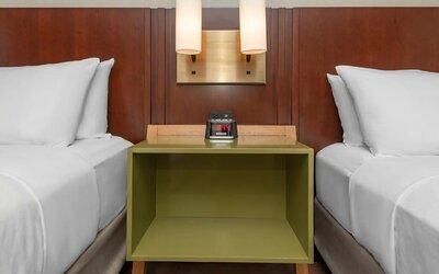 Nightstand between two beds with bedside lighting at Comfort Inn Ottawa East.
