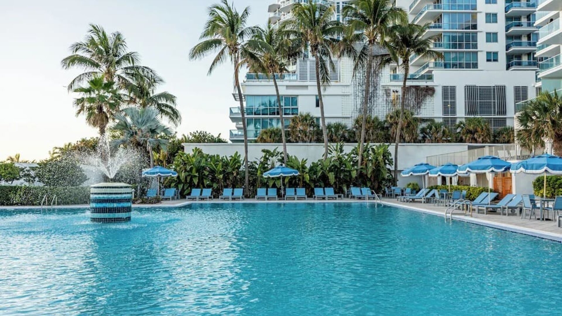 Outdoor swimming pool with palm trees at Sherry Frontenac Oceanfront Hotel.