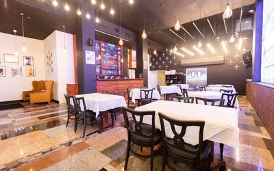 Hotel restaurant with indoor dining tables and ambient lighting at Sherry Frontenac Oceanfront Hotel.