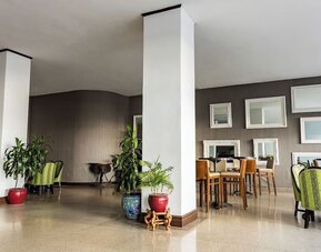 Hotel lounge area with seating and decorative mirrors at Sherry Frontenac Oceanfront Hotel.