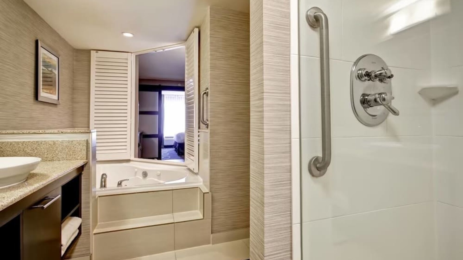 Guest bathroom with shower and tub at Fairfield By Marriott Guelph.