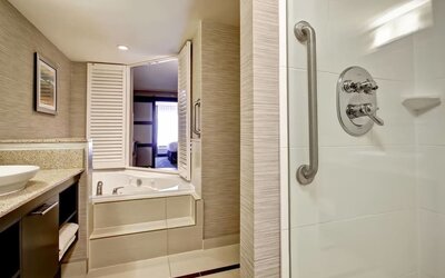 Guest bathroom with shower and tub at Fairfield By Marriott Guelph.