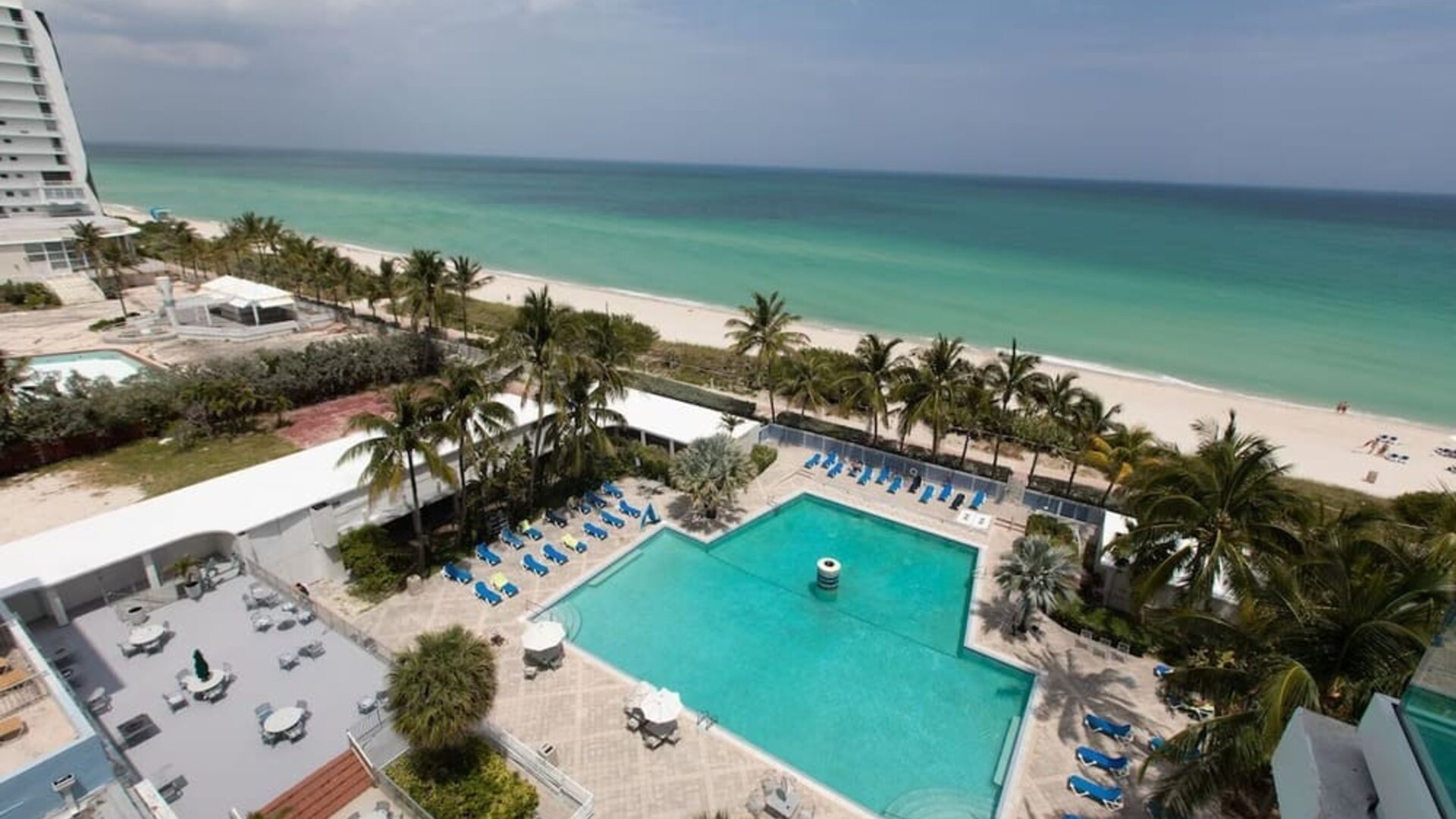 Elevated view of the outdoor pool and beachfront at Sherry Frontenac Oceanfront Hotel.Oceanfront guest room with two beds, workspace, and private balcony at Sherry Frontenac Oceanfront Hotel.