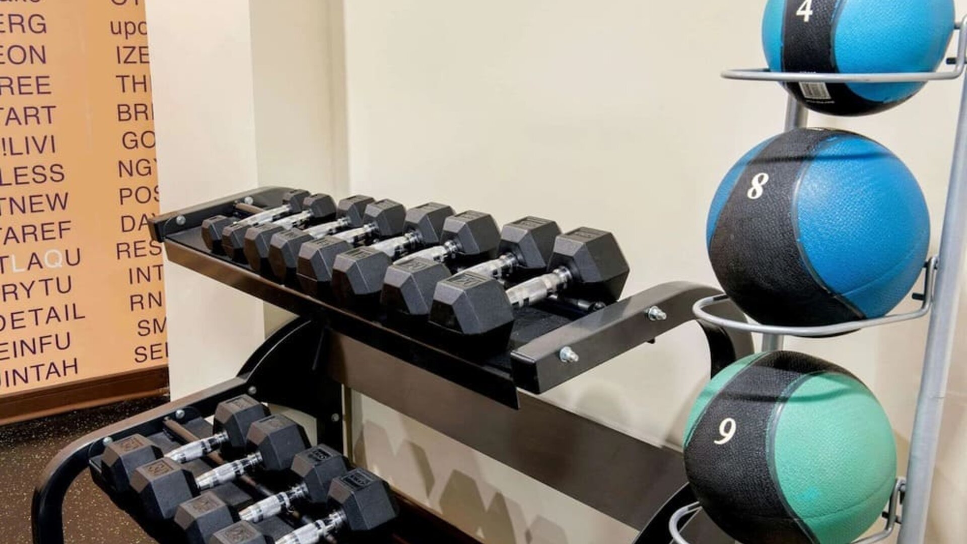 Fitness center with free weights and medicine balls at La Quinta Inn & Suites By Wyndham 