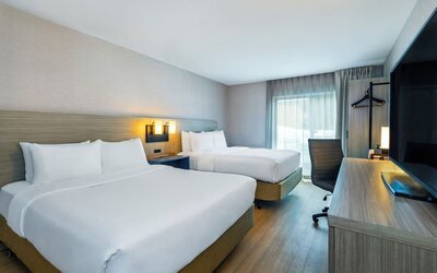 Guest room with two queen beds and a work desk at Comfort Inn Saskatoon.