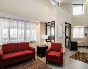 Hotel lobby seating area with large windows at Comfort Inn Saskatoon.