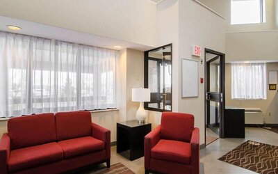 Hotel lobby seating area with large windows at Comfort Inn Saskatoon.