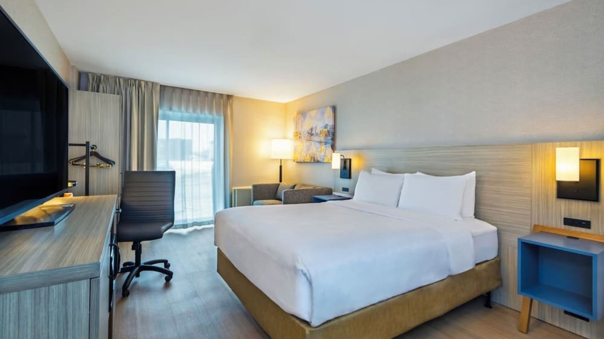 Guest room with a king bed and work desk at Comfort Inn Saskatoon.