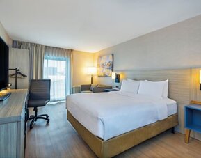 Guest room with a king bed and work desk at Comfort Inn Saskatoon.