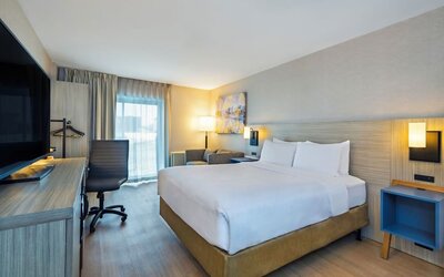 Guest room with a king bed and work desk at Comfort Inn Saskatoon.
