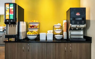 Breakfast station with coffee, juice, and fresh fruit at Comfort Inn Saskatoon.