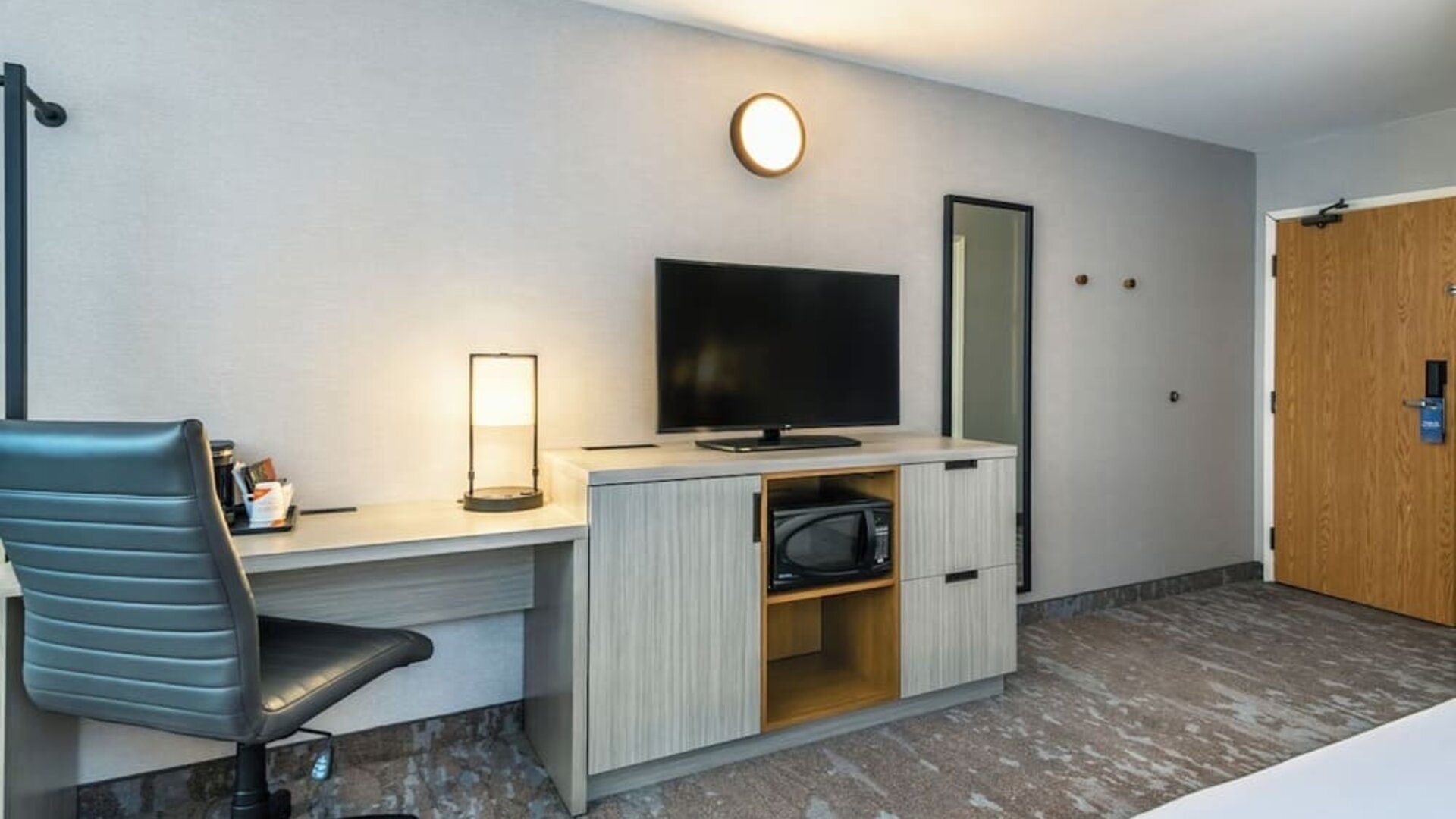 In-room workspace with a desk, TV, and microwave at Comfort Inn Saskatoon.
